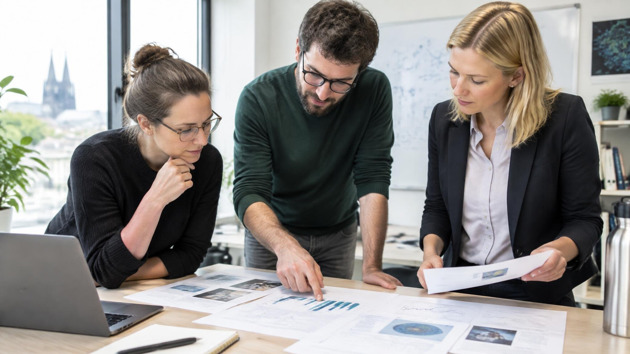 Researchers reviewing printed reports together at a table